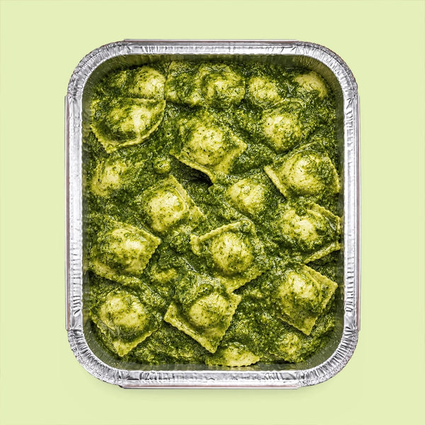 Tray of italian ravioli with pesto sauce for office catering