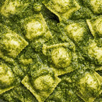 Close-up of ravioli with a green pesto sauce