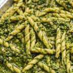 Close-up of green pesto Trofie pasta in a metal pan