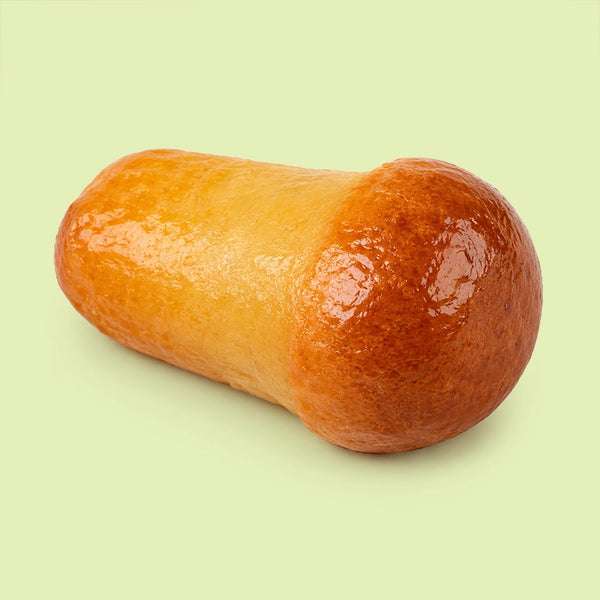 Mini Sicilian baba pastries, syrup soaked and glazed, shown plain.