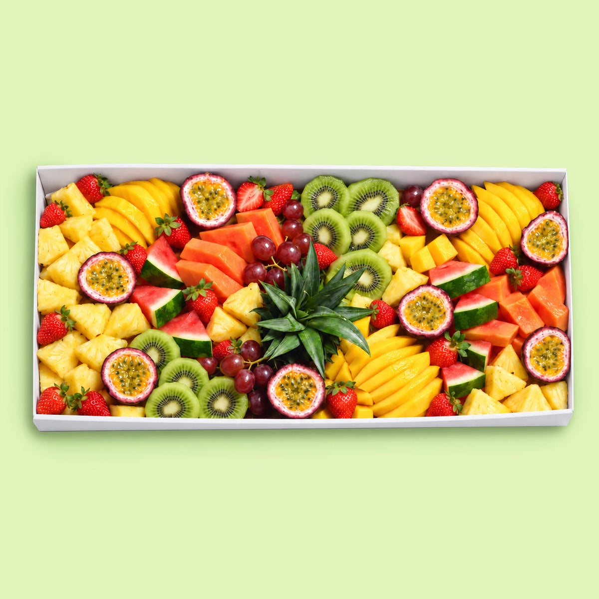 Large tropical fruit platter with pineapple, mango, papaya, watermelon, kiwi, strawberries, red grapes and fresh passionfruit halves