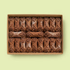 Box of chocolate Cannoli on a light green background