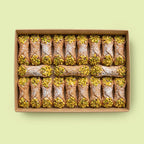 Box of cannoli with pistachios on a light green background