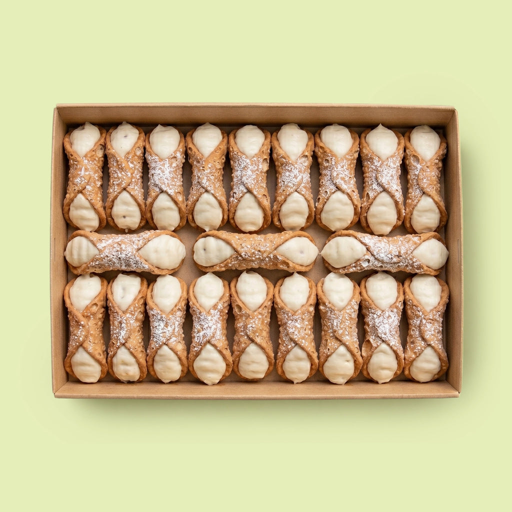 Box of Ricotta Plain cannoli on a light green background