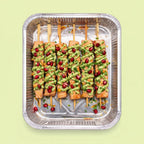 Grilled salmon skewers with citrus avocado and pomegranate for canapé catering Sydney CBD