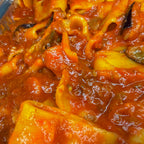 Close-up of pasta with oxtail beef tomato red sauce and eggplants