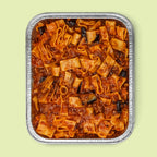 Foil-tray of pasta dish with oxtail beef sauce and eggplants on a light green background