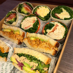 Assorted sandwiches including wraps and slices in a box