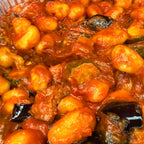 Close-up of a dish with gnocchi and norma sauce with eggplant
