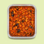 Italian pasta gnocchi with Norma tomato sauce and eggplant in a metal tray on a light green background