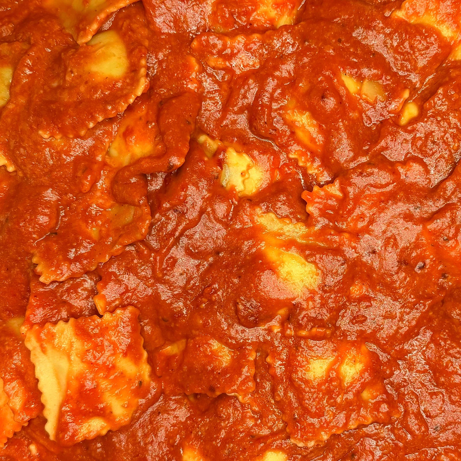 Close-up of a red sauce with ravioli Italian pasta, from a office catering.