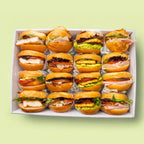 Box of 16 mini burgers with various fillings on a light green background